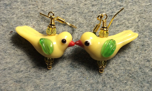 Opaque yellow and green lamp work songbird bead earrings adorned with yellow Chinese crystal beads.