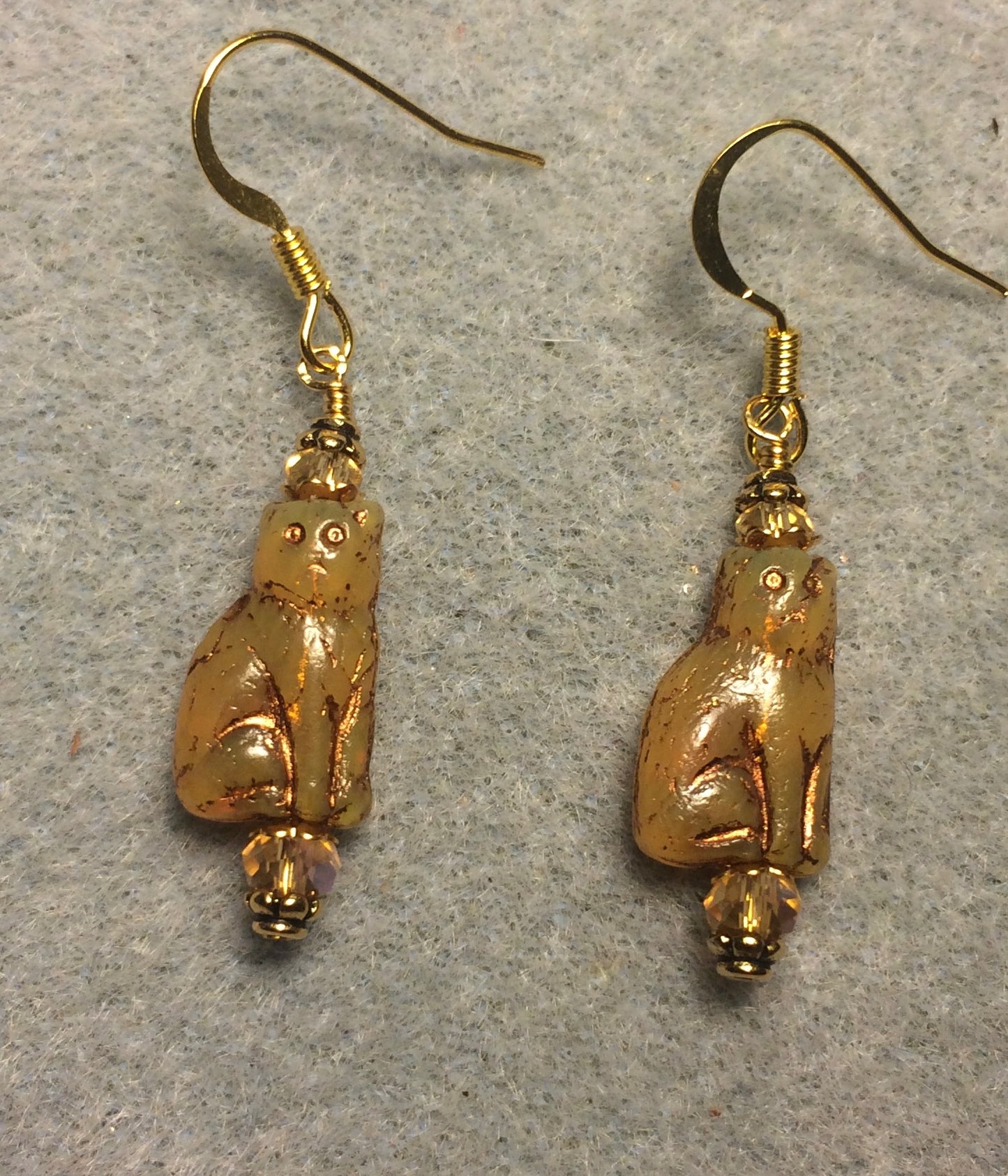 Small opaque topaz and gold Czech glass cat bead earrings adorned with topaz Chinese crystal beads.