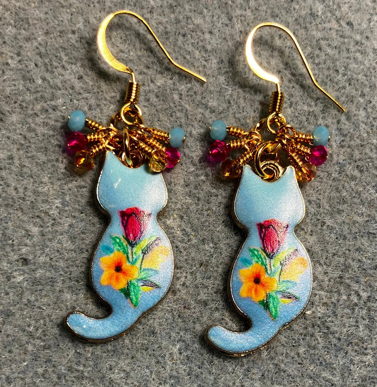 Light blue, hot pink, and amber enamel cat charm earrings adorned with tiny dangling light blue, hot pink, and amber Chinese crystal beads.