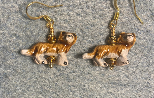 Small amber and beige ceramic lion bead earrings adorned with amber Chinese crystal beads.