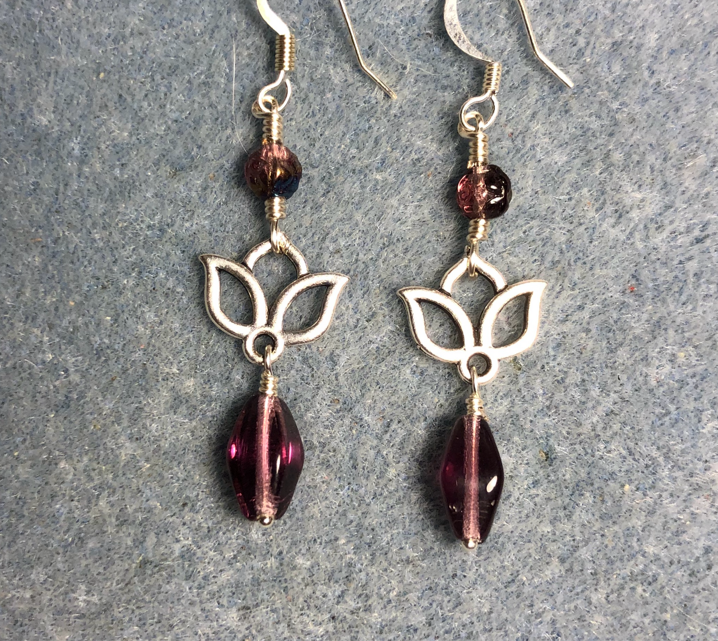 Small silver lotus flower connector charm earrings adorned with violet Czech glass drop beads and violet Czech glass rosebud beads.