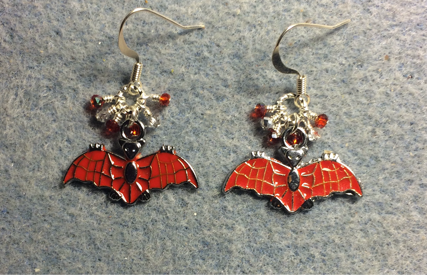 Red and silver enamel bat charm earrings adorned with tiny dangling red and silver Chinese crystal beads.