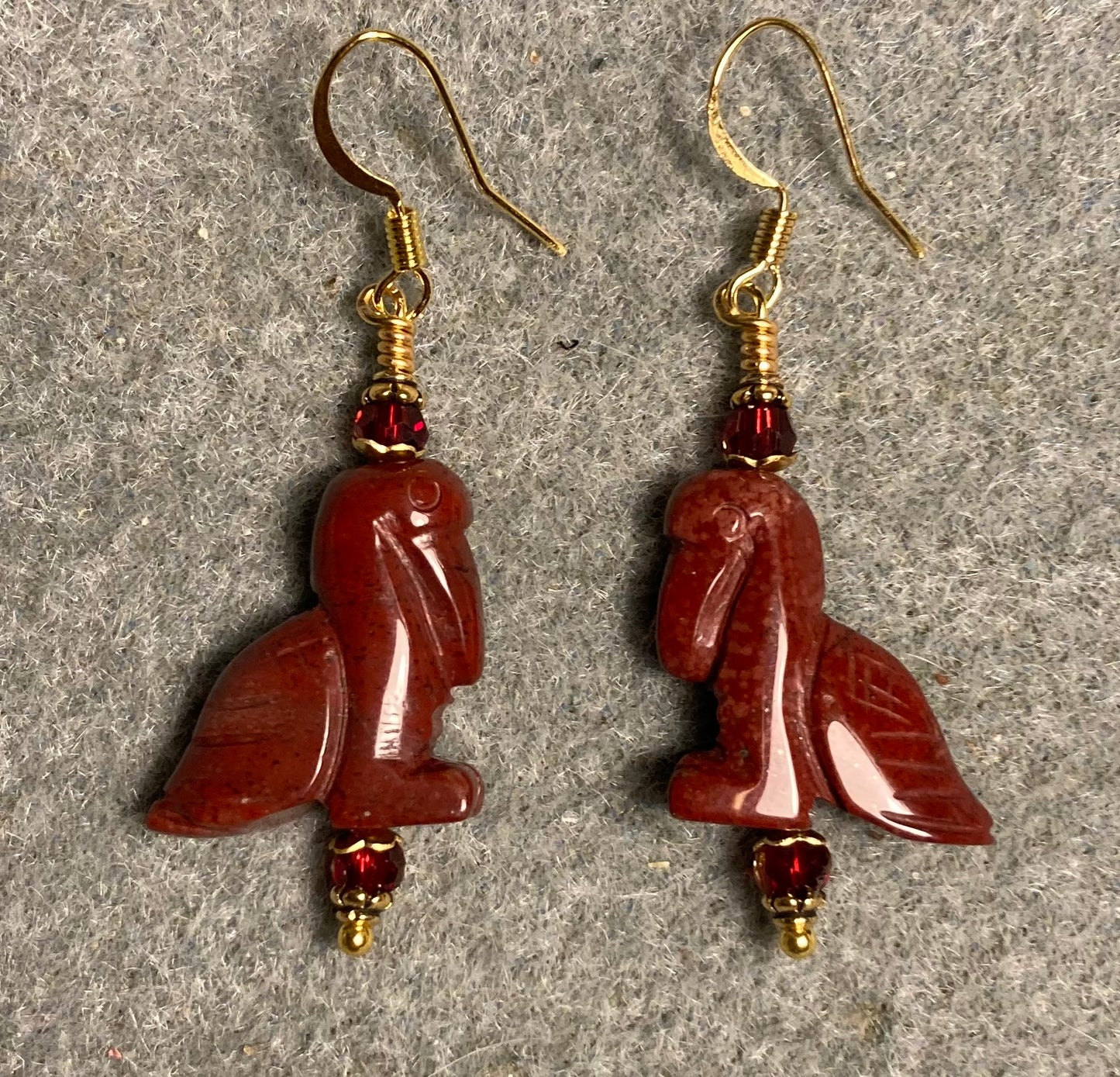 Red poppy jasper gemstone pelican bead earrings adorned with dark red Chinese crystal beads.