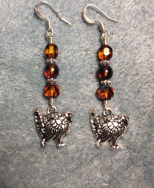 Silver turkey charm earrings adorned with topaz Czech glass beads.