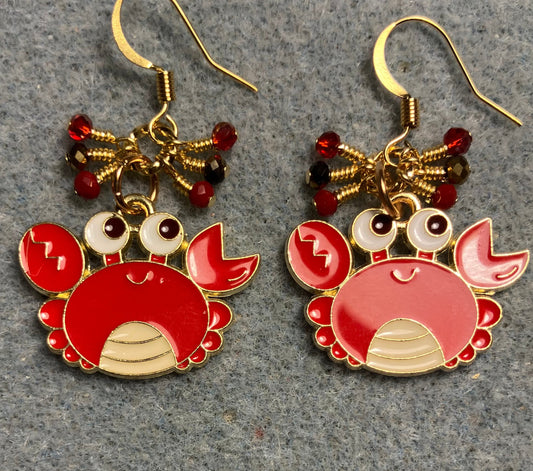 Large red, black, and white enamel crab charm earrings adorned with tiny dangling red and gold Chinese crystal beads.