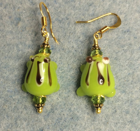 Lime green with black stripes lamp work frog bead earrings adorned with lime green Chinese crystal beads.