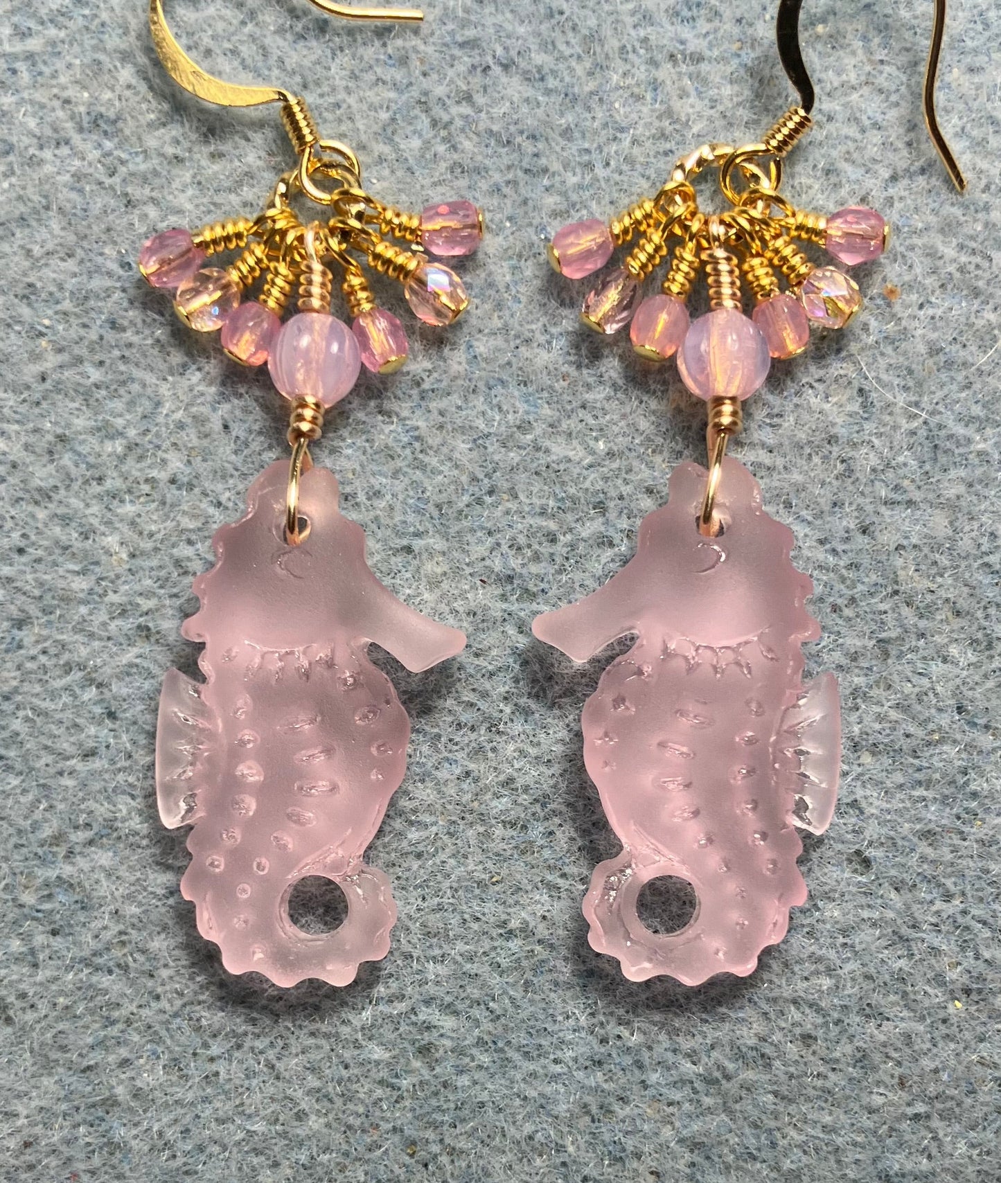 Pink sea glass seahorse pendant bead earrings adorned with pink Czech glass beads and tiny dangling pink Czech glass beads.