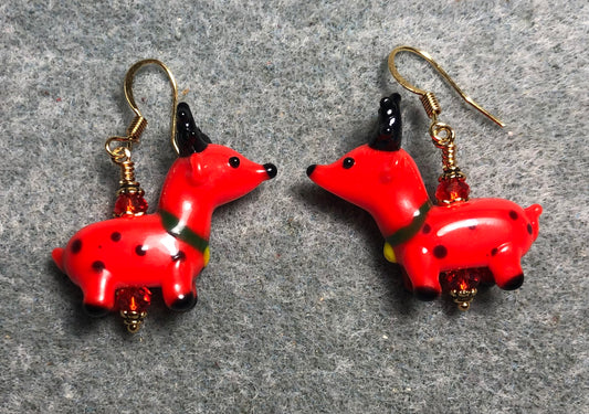 Red and black lamp work reindeer bead earrings adorned with red Chinese crystal beads.