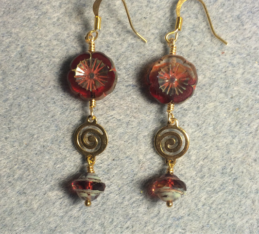 Cranberry red Czech glass pansy bead earrings adorned with gold swirly connectors and cranberry red Czech glass Saturn beads.