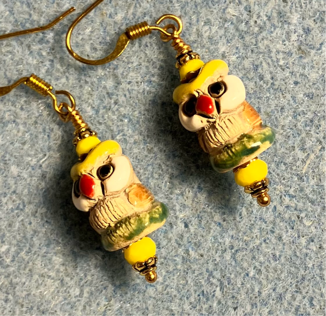 Small tan, yellow, and green ceramic owl bead earrings adorned with yellow Chinese crystal beads.