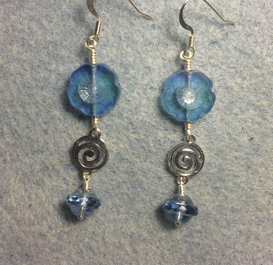 Translucent light blue Czech glass pansy bead earrings adorned with silver swirly connectors and light blue Czech glass Saturn beads.