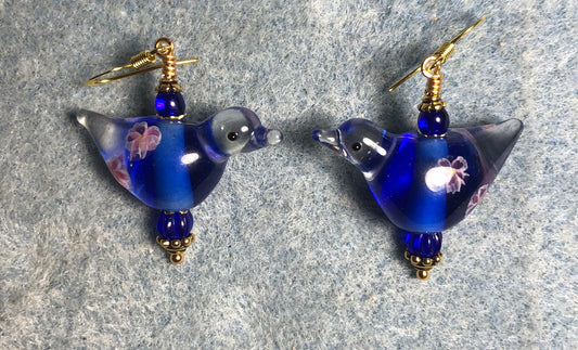 Translucent dark blue lamp work songbird bead earrings adorned with dark blue Czech glass beads.