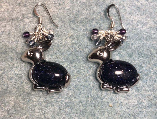 Large silver and blue goldstone gemstone rabbit charm earrings adorned with small dangling purple and silver Czech glass beads.
