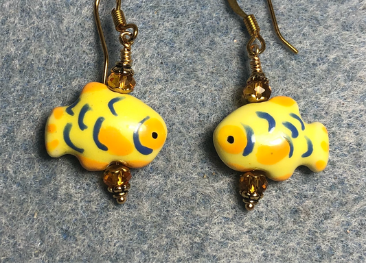 Small yellow and orange ceramic fish bead earrings adorned with orange Chinese crystal beads.