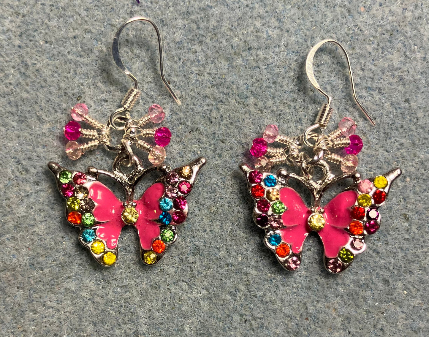 Hot pink enamel and colored rhinestone butterfly charm earrings adorned with tiny dangling hot pink and light pink Chinese crystal beads.