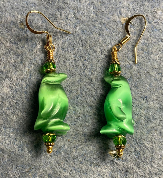 Green fiber optic (cat’s eye) penguin bead earrings adorned with green Chinese crystal beads.