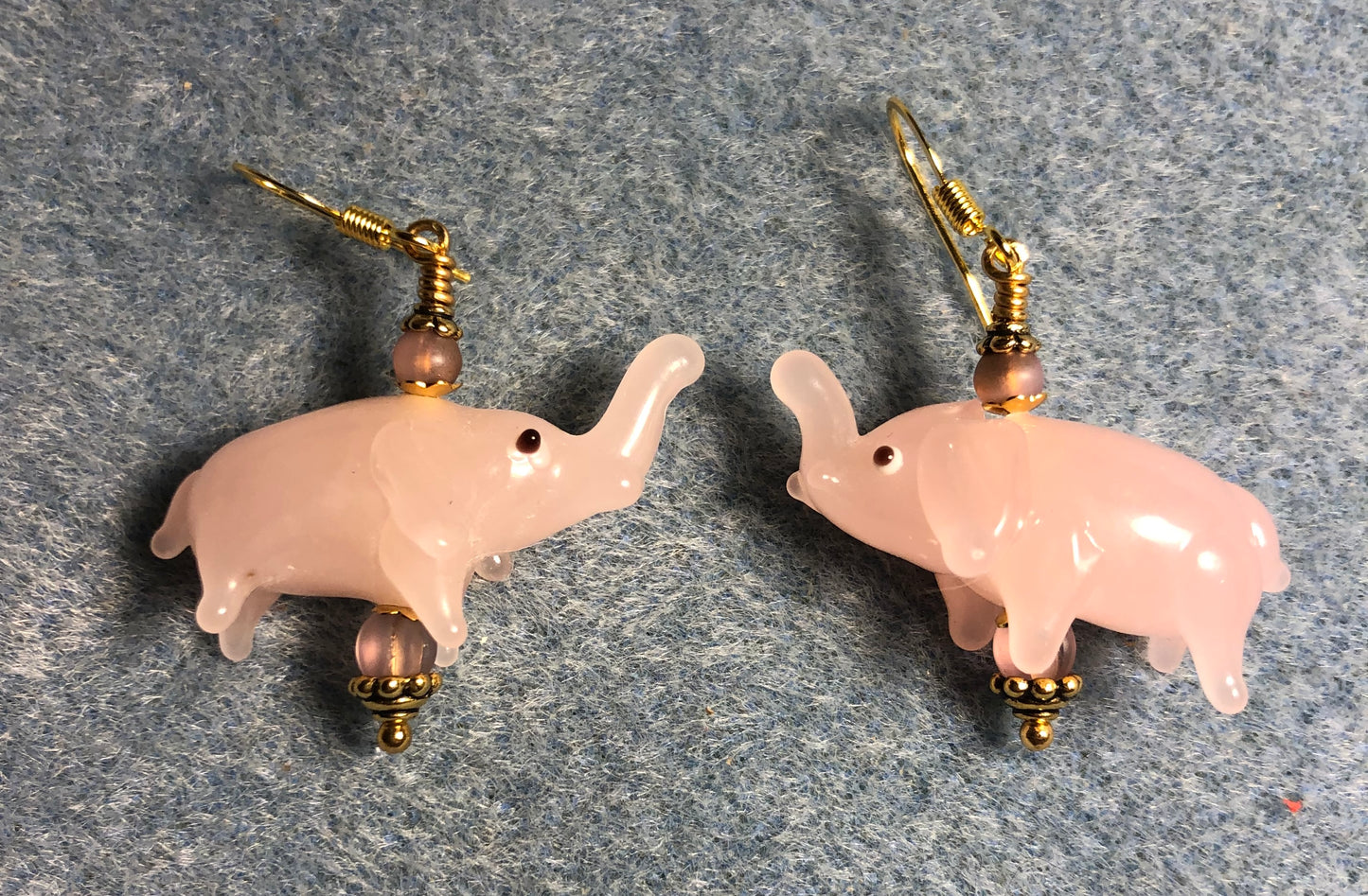 Opaque light pink lamp work elephant bead earrings adorned with light pink Czech glass beads.