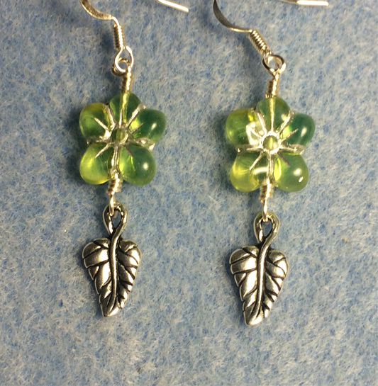 Light green (with silver inlay) Czech glass puffy flower bead earrings adorned with silver Tierracast leaf charms.