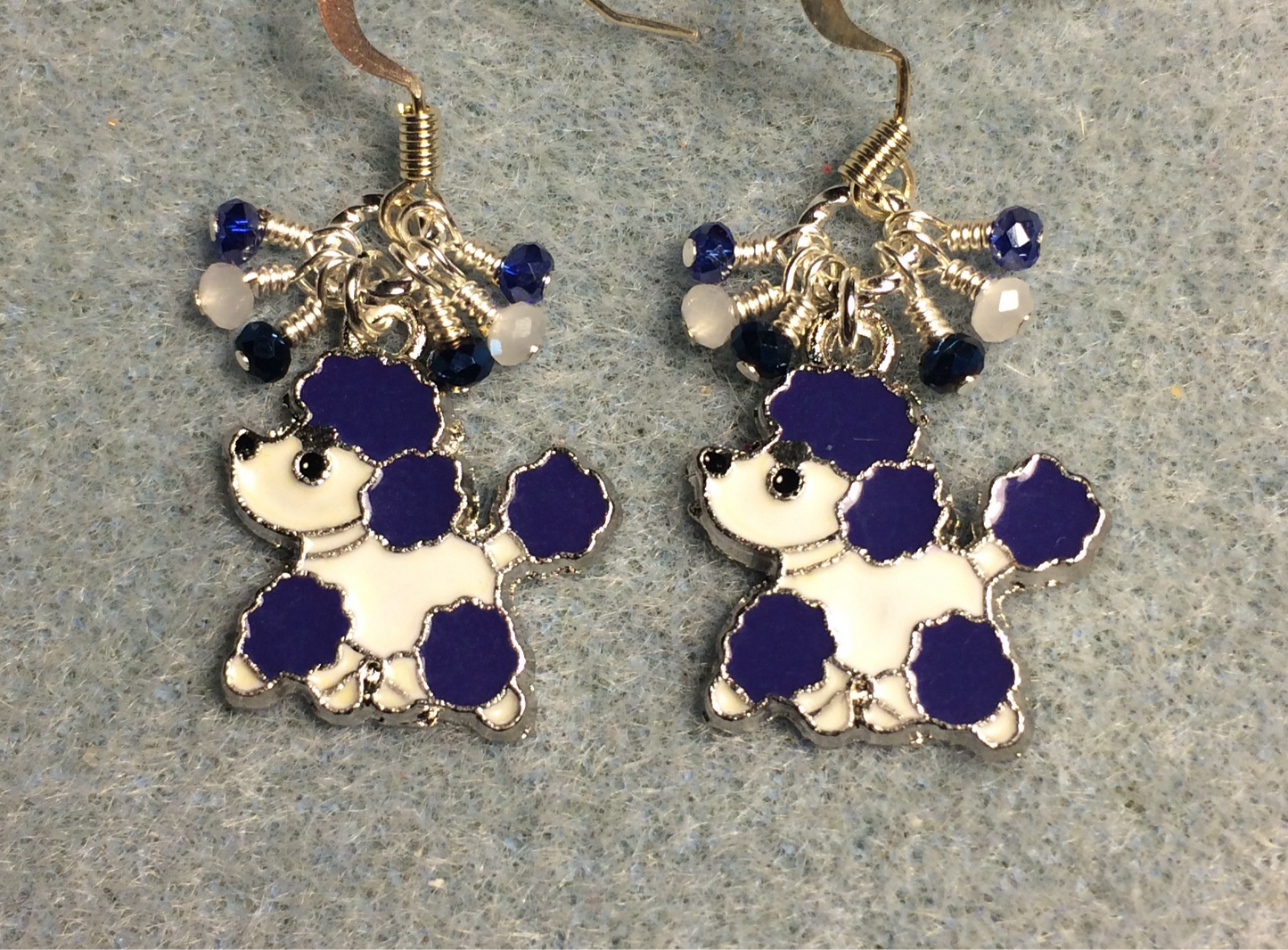 Dark blue and white enamel poodle charm earrings adorned with tiny dangling dark blue and white Chinese crystal beads.