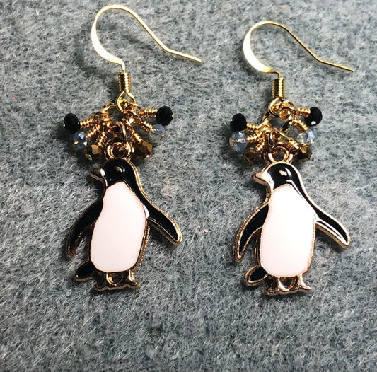 Black enamel and white shell penguin charm earrings adorned with tiny dangling black, gold, and clear Chinese crystal beads.