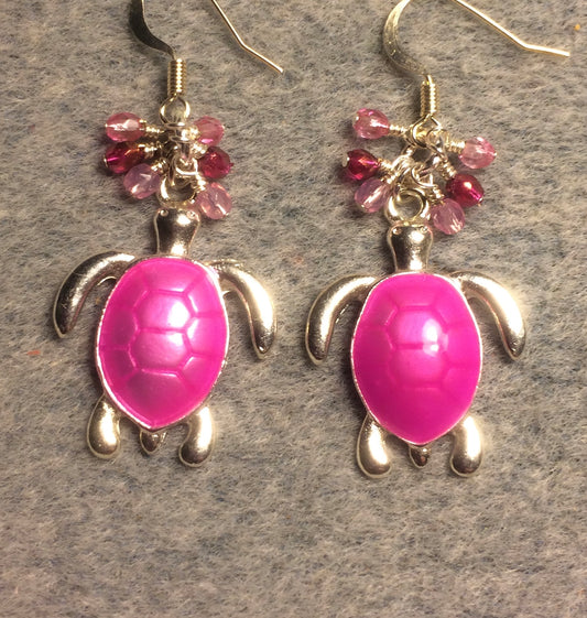 Bright pink enamel sea turtle charm earrings adorned with small dangling pink Czech glass beads.