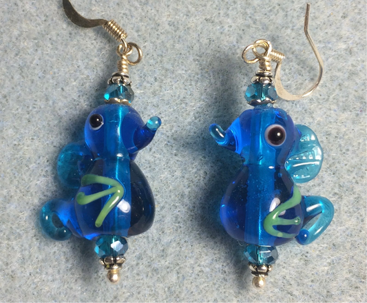 Turquoise blue lamp work seahorse bead earrings adorned with turquoise Chinese crystal beads.