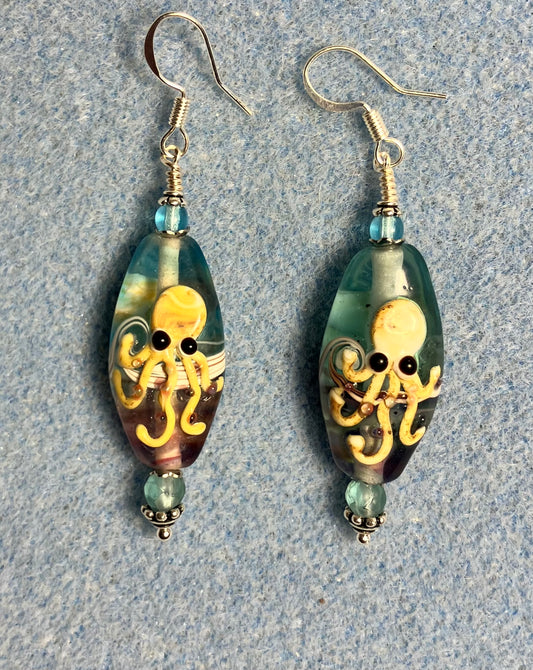 Light aqua and tan lamp work octopus bead earrings adorned with light aqua Chinese crystal beads.