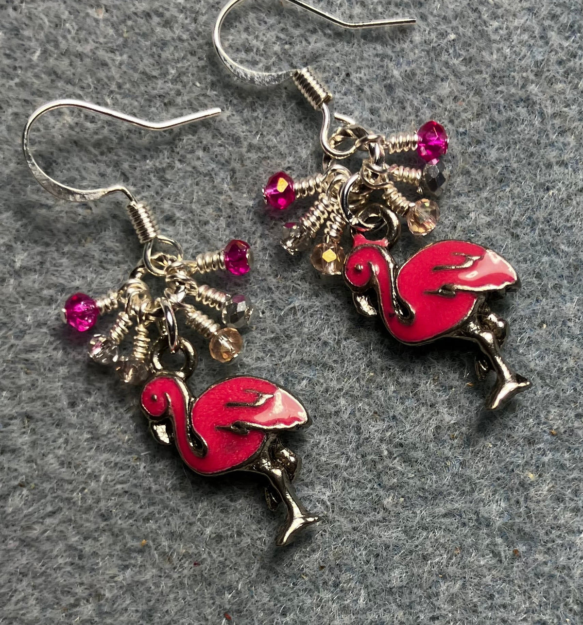 Hot pink enamel flamingo charm earrings adorned with tiny dangling hot pink, light pink, and silver Chinese crystal beads.