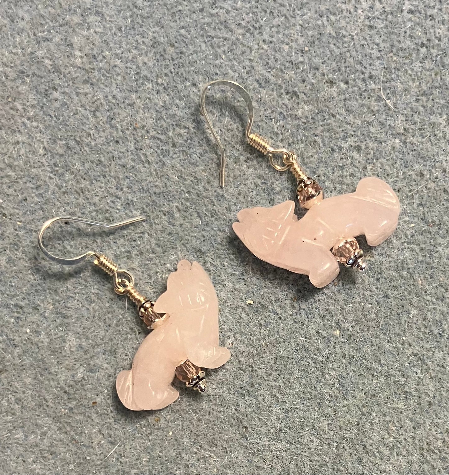 Pink quartz gemstone howling coyote bead earrings adorned with pink Chinese crystal beads.