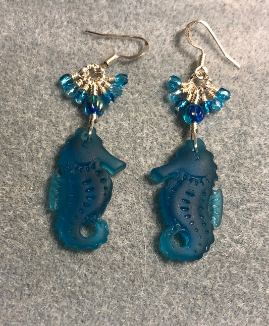 Dark turquoise sea glass seahorse pendant bead earrings adorned with dark turquoise Czech glass beads and tiny dangling dark turquoise Czech glass beads.