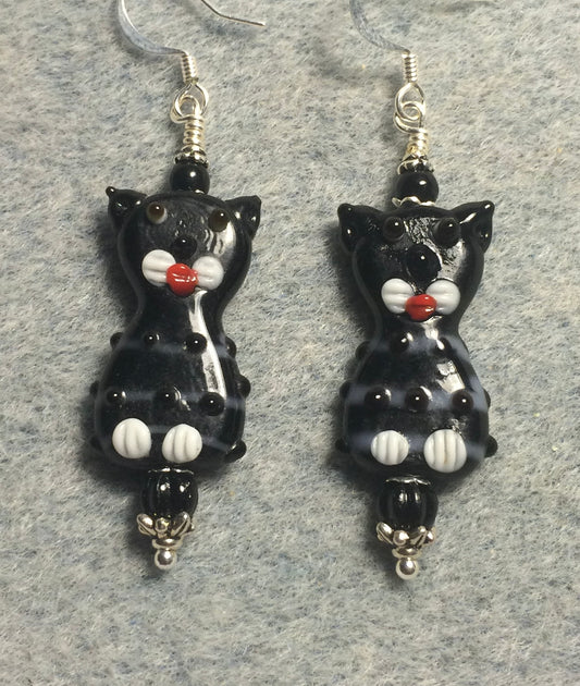 Black, white, and red lamp work cat bead earrings adorned with black Czech glass beads.