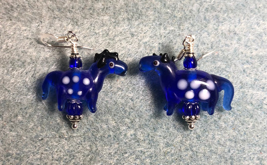 Translucent dark blue lamp work spotted horse bead earrings adorned with dark blue Czech glass beads.