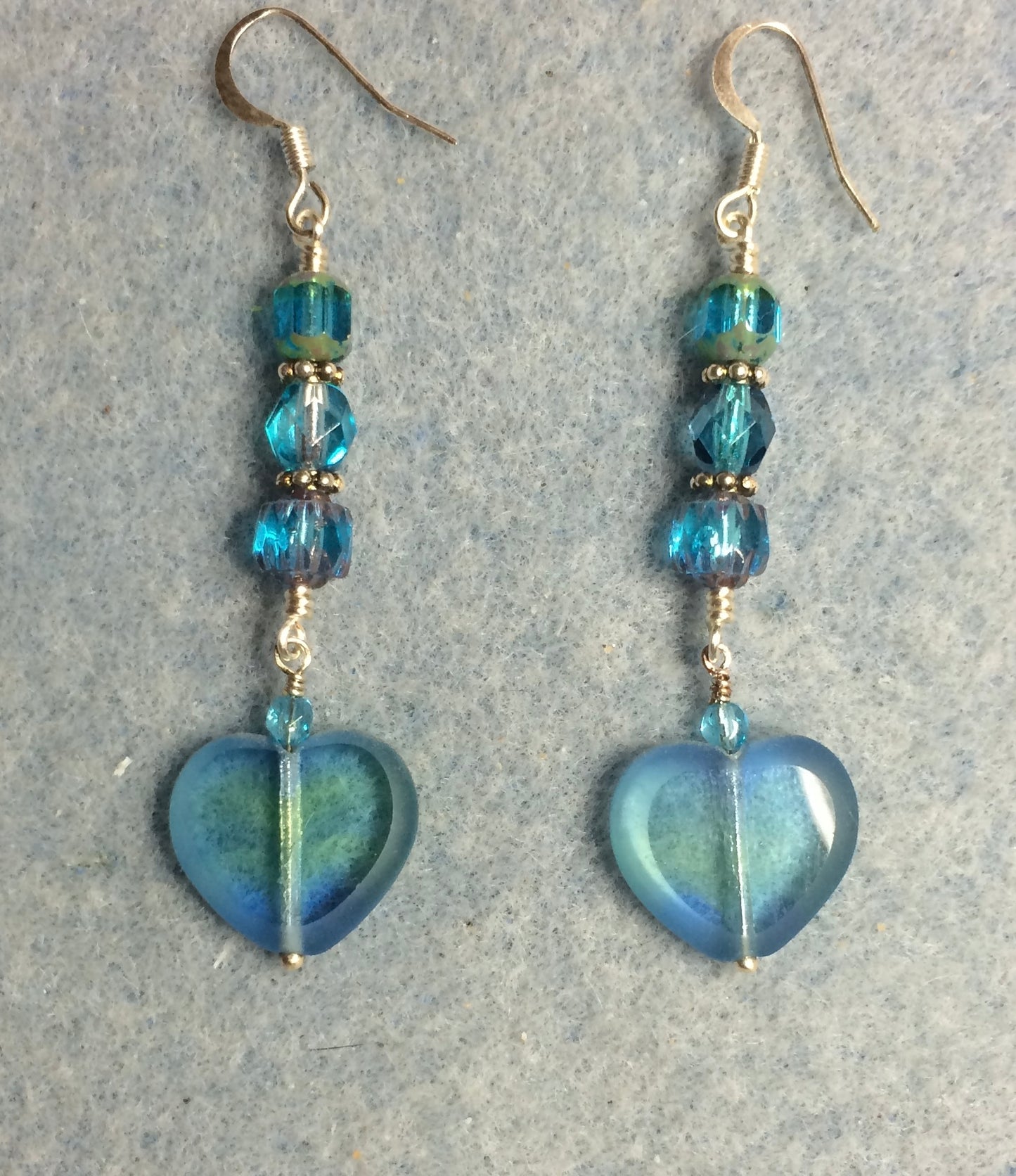 Translucent turquoise and green Czech glass heart bead earrings adorned with turquoise Czech glass beads.