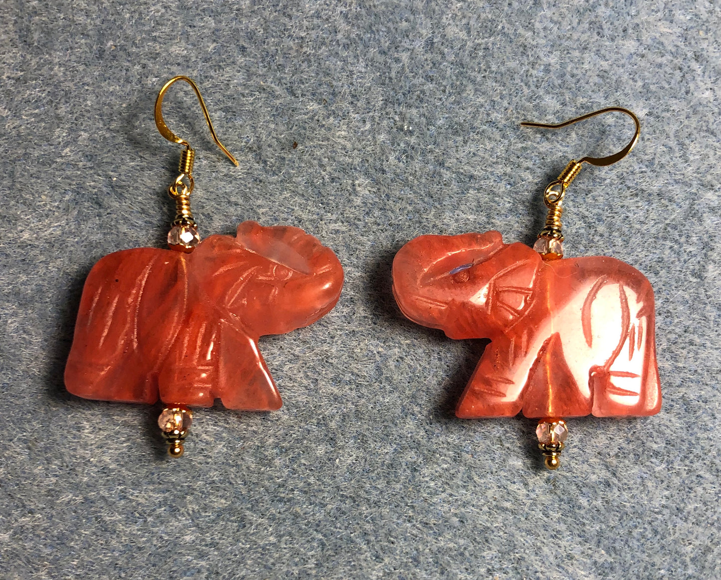 Large cherry quartz gemstone elephant bead earrings adorned with peach Chinese crystal beads.