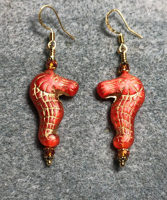 Orange (with gold inlay) Czech glass seahorse bead earrings adorned with orange Chinese crystal beads.