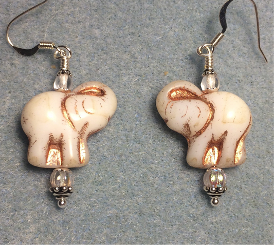 White (with copper inlay) Czech glass elephant bead earrings adorned with clear Czech glass beads.