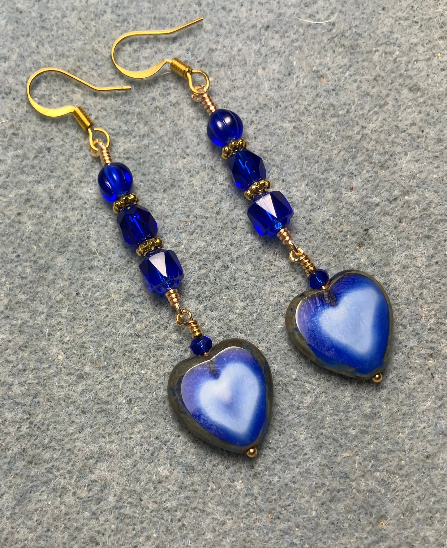 Opaque blue Czech glass heart bead earrings adorned with blue Czech glass beads.