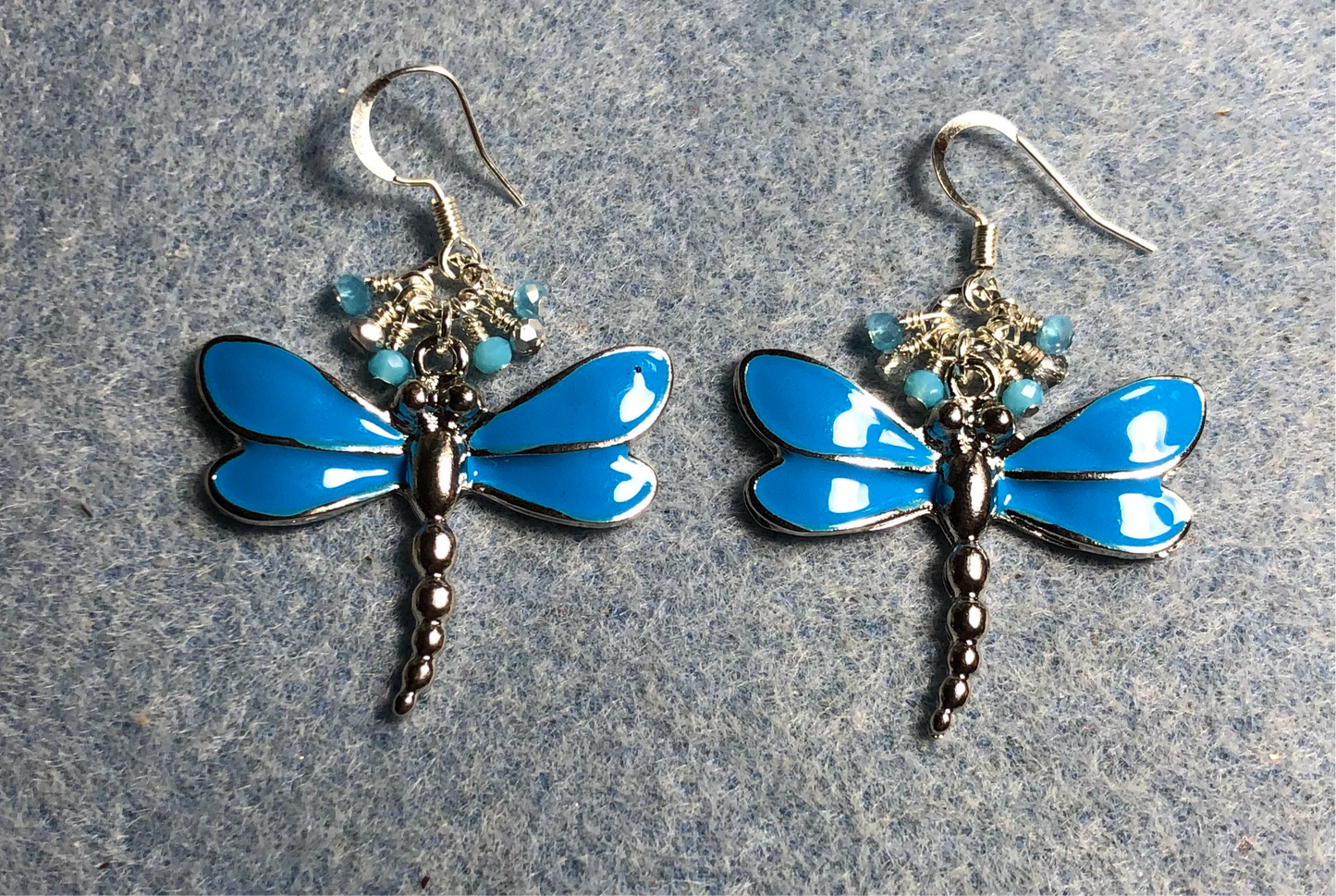 Large turquoise blue and silver enamel dragonfly charm earrings adorned with tiny dangling turquoise and silver Chinese crystal beads.