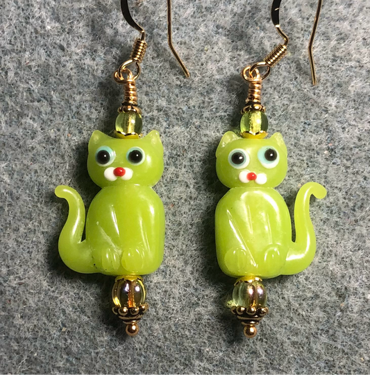 Opaque lime green lamp work cat bead earrings adorned with lime green Czech glass beads.
