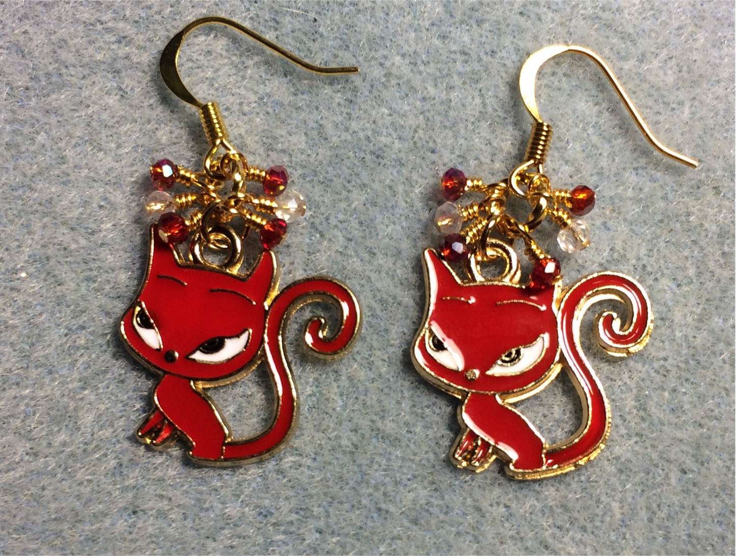 Red, gold, and white enamel fox (or devil cat) charm earrings adorned with tiny dangling red and clear Chinese crystal beads.