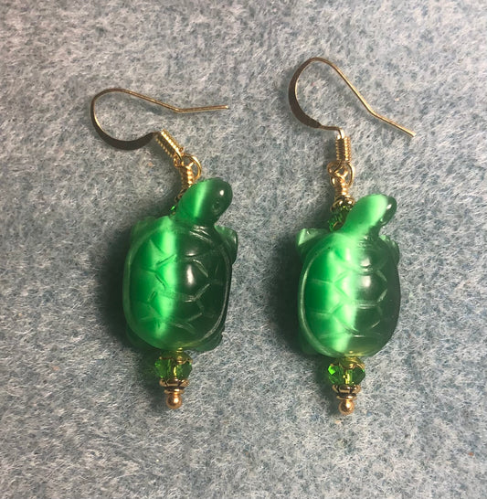 Green fiber optic (cat’s eye) turtle bead earrings adorned with green Chinese crystal beads.