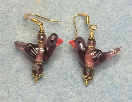 Translucent violet lamp work songbird bead earrings adorned with violet Czech glass beads.