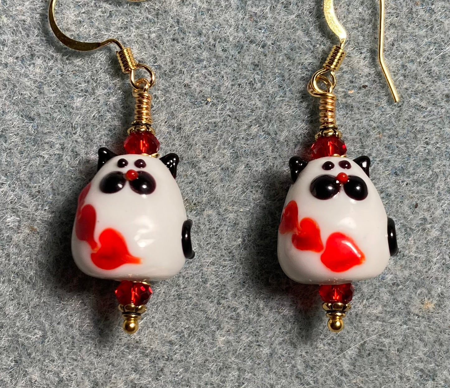 White, red, and black lamp work cat (with red hearts) bead earrings adorned with red Chinese crystal beads.