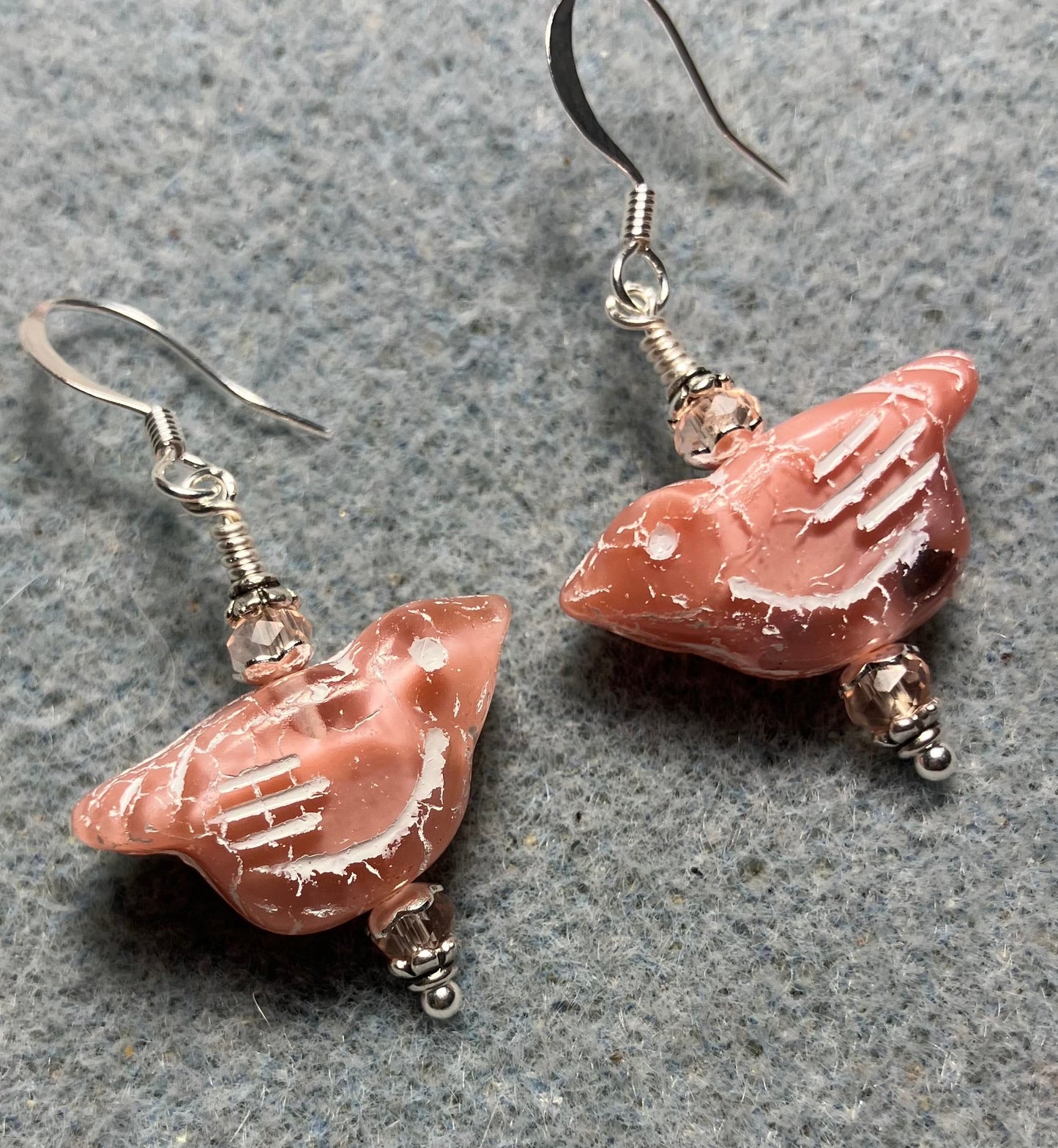 Light pink (with light pink wash) Czech glass bird bead earrings adorned with light pink Chinese crystal beads.