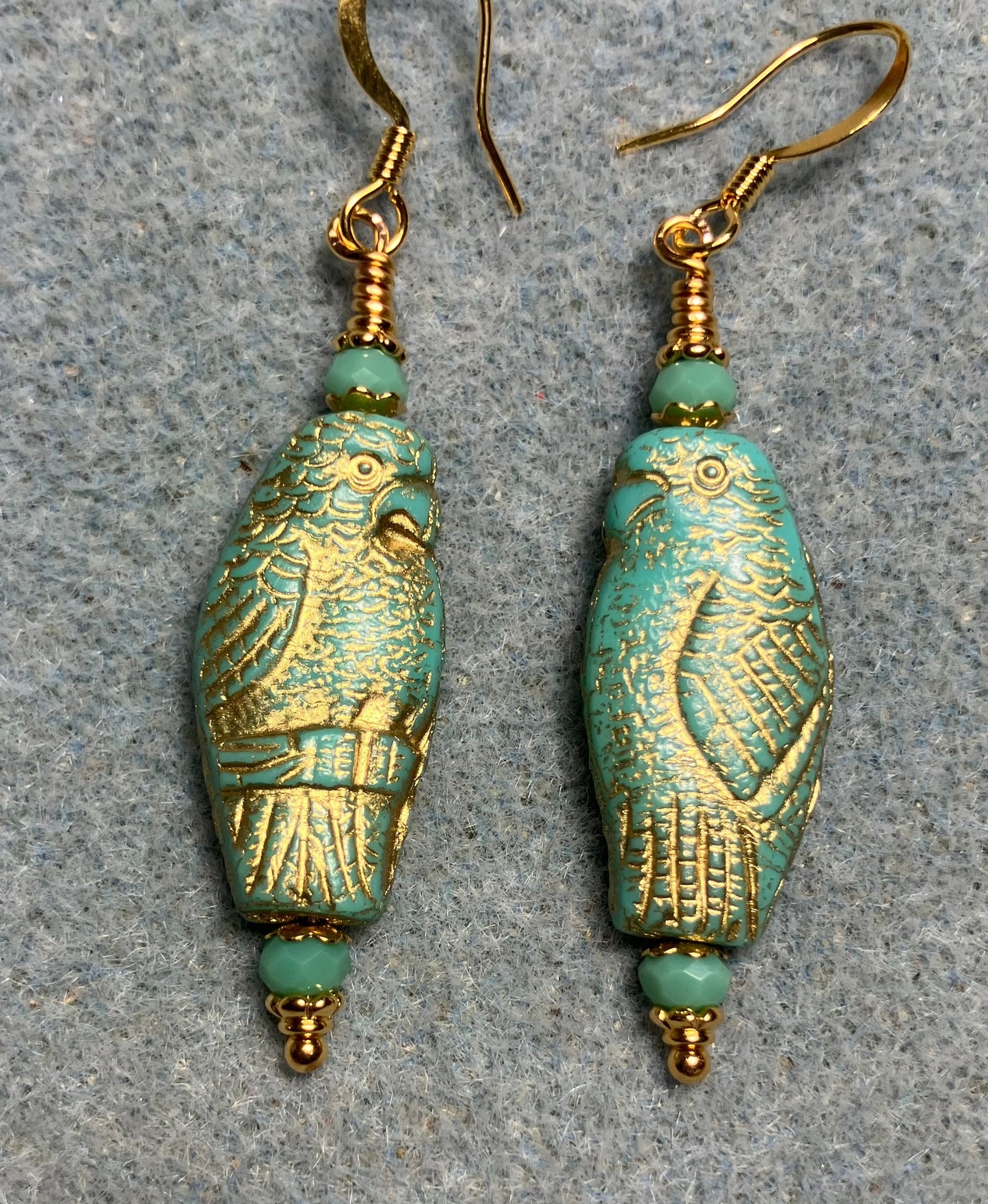 Large turquoise (with gold wash) Czech glass parrot bead earrings adorned with turquoise Chinese crystal beads.