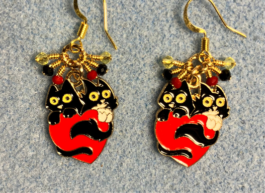 Black, red, and yellow enamel cat charm earrings adorned with tiny dangling black, red, and yellow Chinese crystal beads.