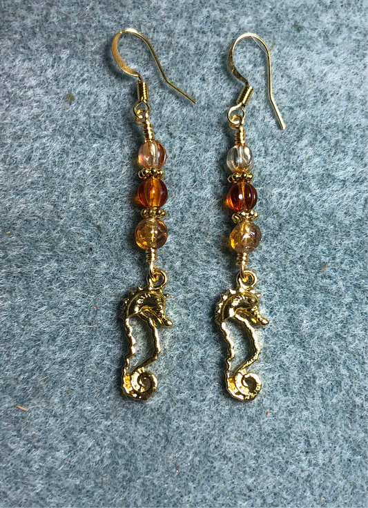 Small gold seahorse charm earrings adorned with small amber Czech glass beads.