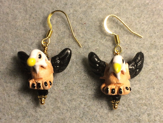 Small black, tan, and yellow ceramic flying eagle bead earrings adorned with black Chinese crystal beads.