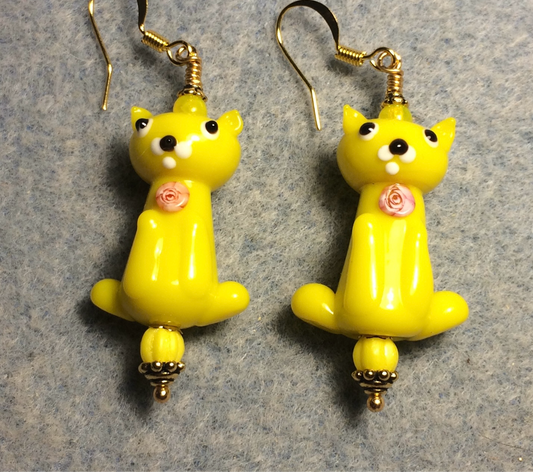 Opaque yellow lamp work cat bead earrings adorned with yellow Czech glass beads.