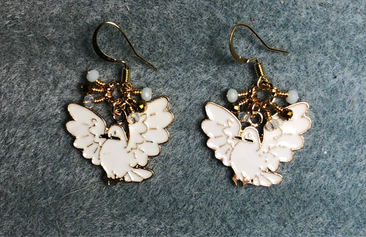 White and gold enamel flying dove charm earrings adorned with tiny dangling white, gold, and clear Chinese crystal beads.